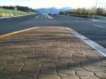 stamped asphalt median random stone pattern anchorage closeup